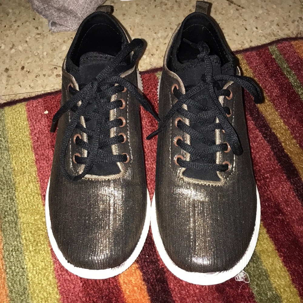 Gold foil and black tennis shoes